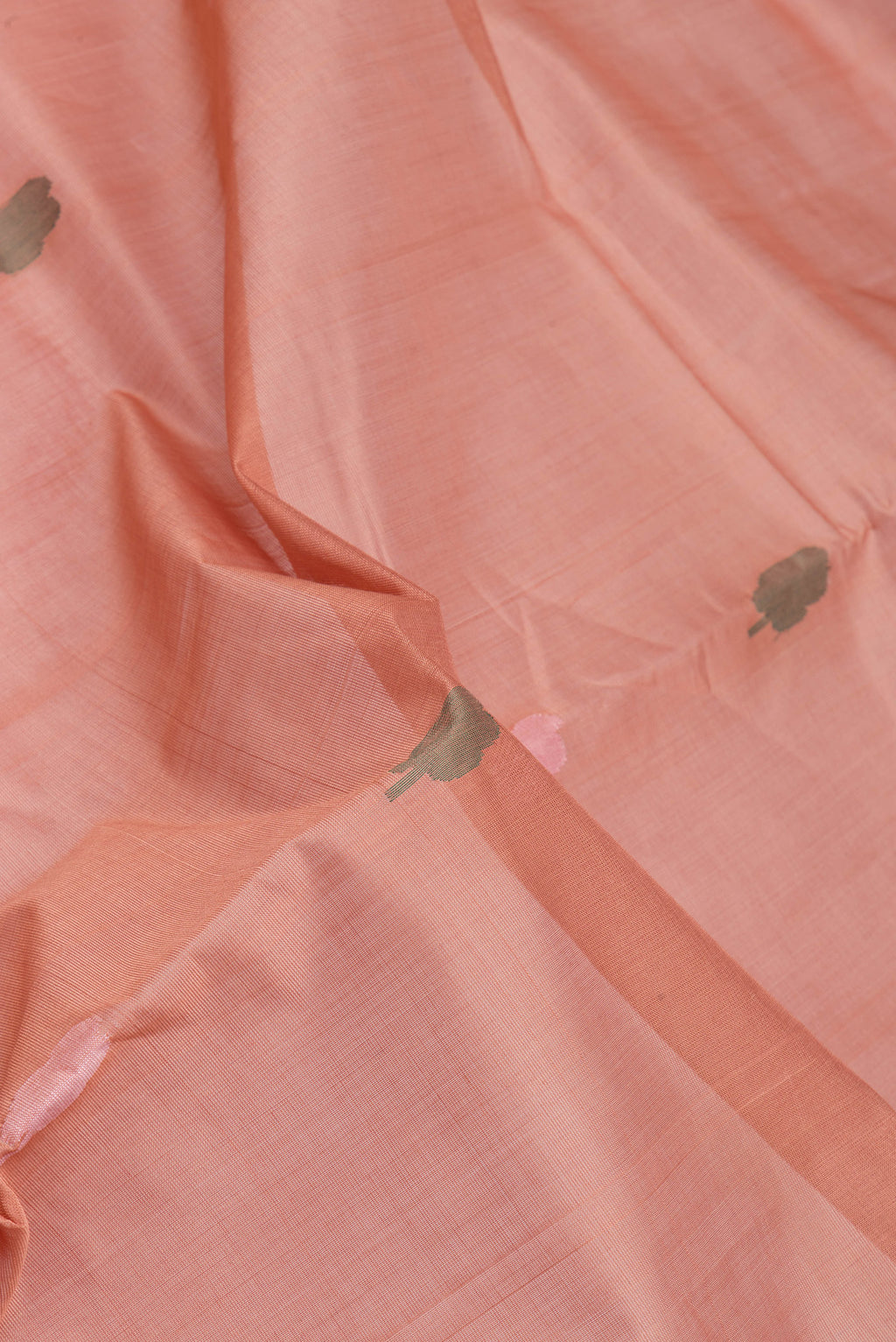 Close up of Rose Gold Uppada Cotton Saree with Thread Butta on the body and Zari Border.  displaying folds