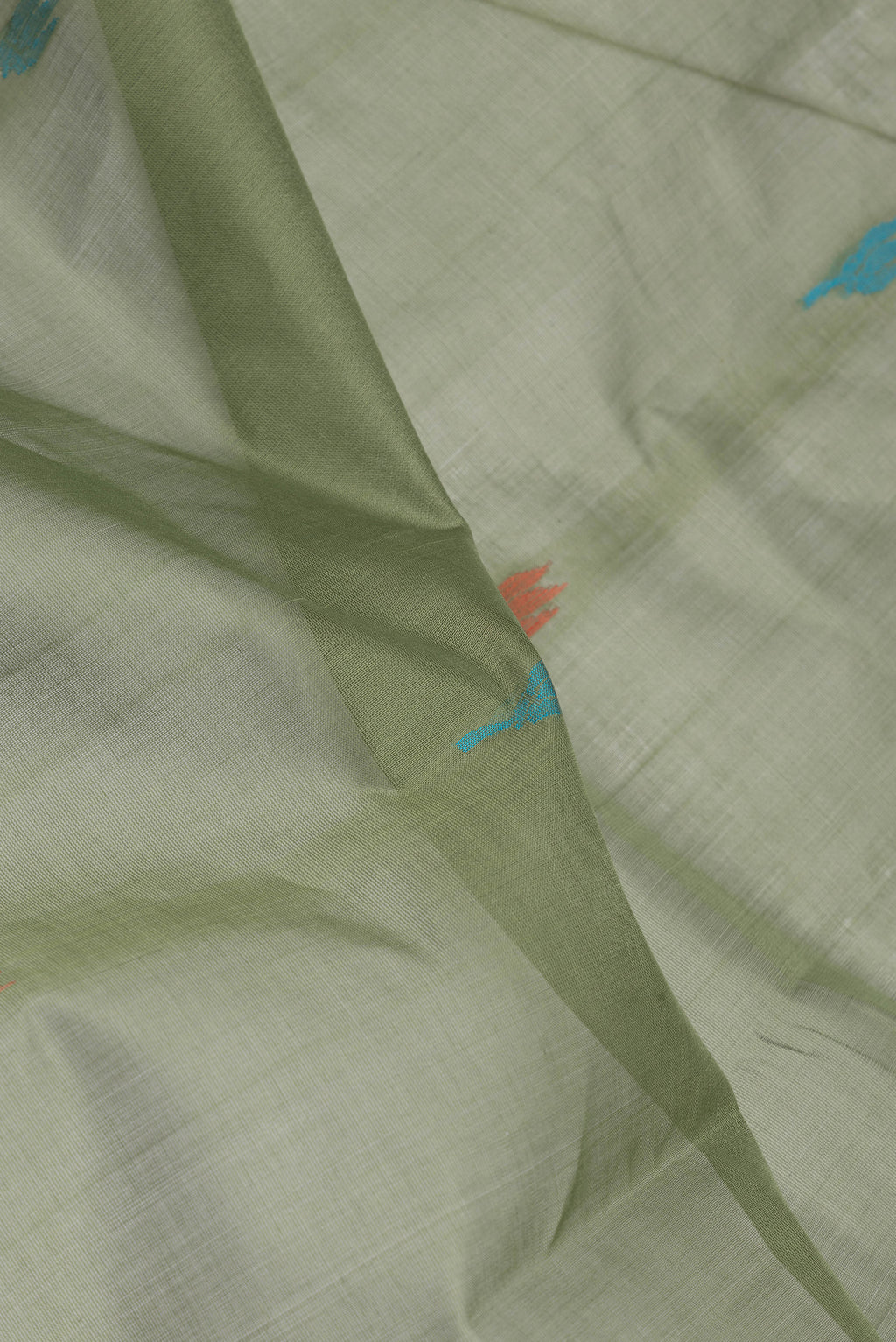 Close up of Mehandi Green Uppada Cotton Saree with Thread Butta on the body and Zari Border.  displaying folds