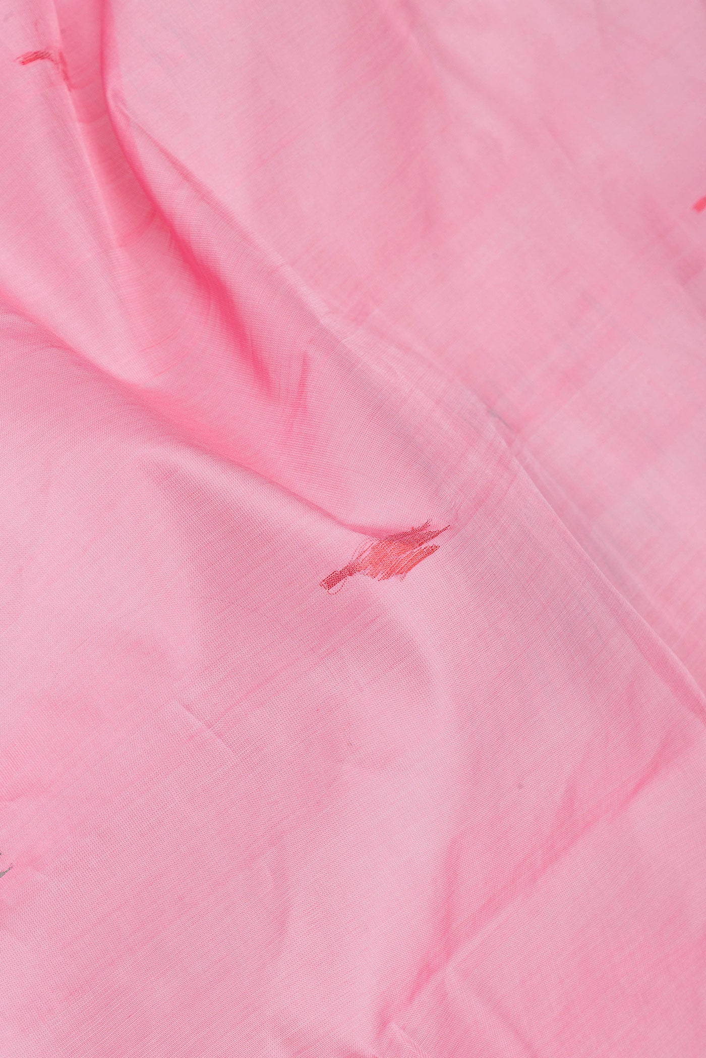 Close up of Pink Uppada Cotton Saree with Thread Butta on the body and Zari Border.  displaying folds