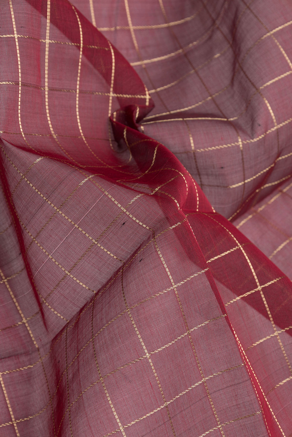Close up of Maroon Dual Tone Silk Cotton Saree with Checked design on the body and Zari Border.  displaying folds