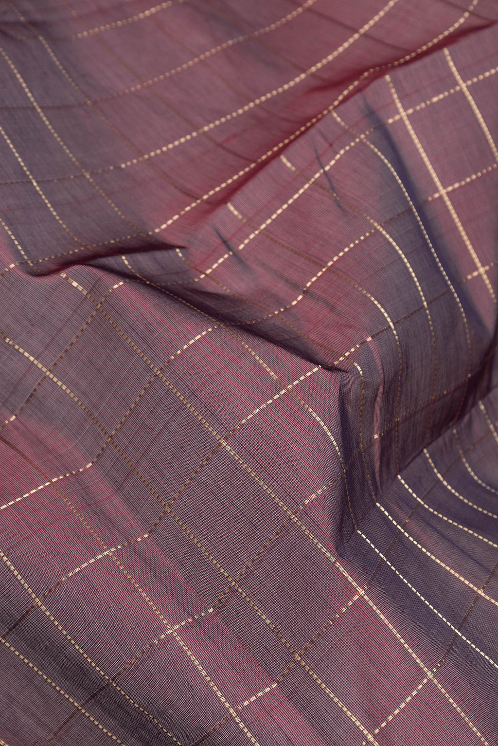 Close up of Maroon Dual Tone Silk Cotton Saree with Checked design on the body and Zari Border.  displaying folds