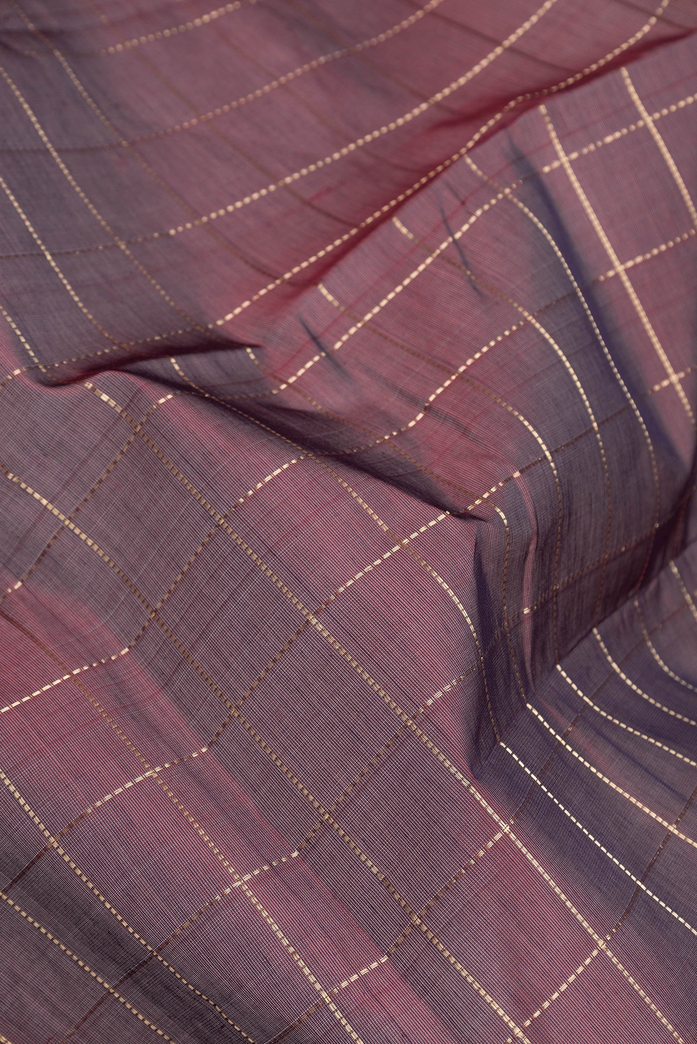 Close up of Maroon Dual Tone Silk Cotton Saree with Checked design on the body and Zari Border.  displaying folds