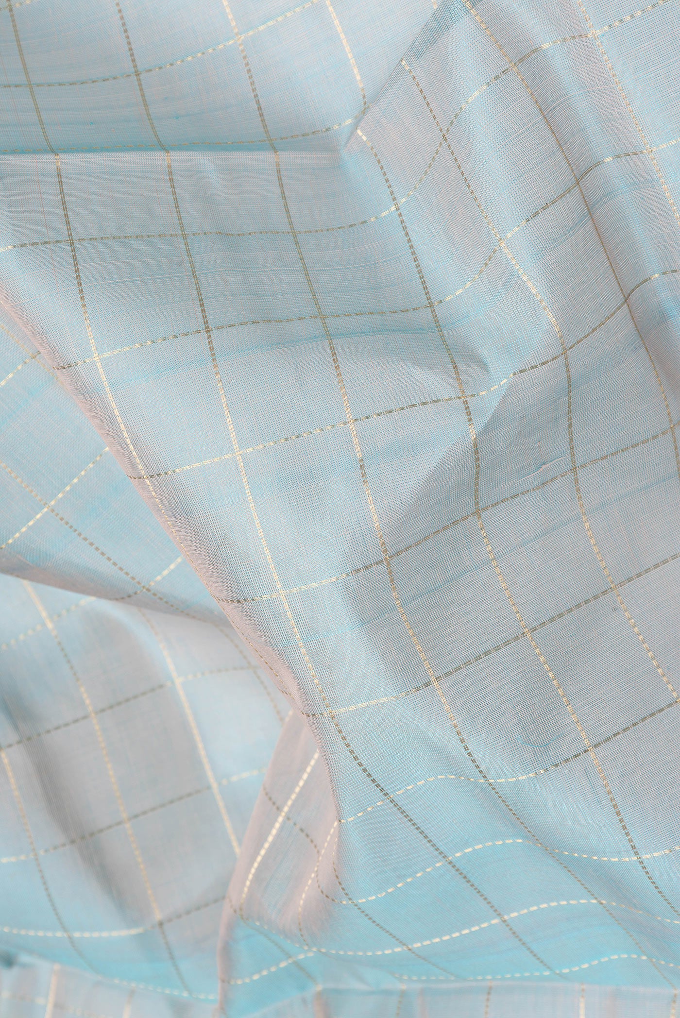 Close up of Sky Blue Dual Tone Silk Cotton Saree with Checked design on the body and Zari Border.  displaying folds