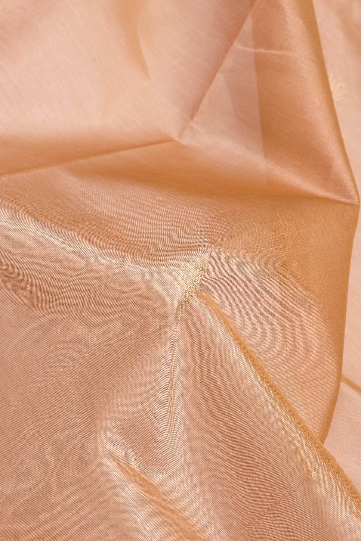 Close up of Peach Dual Tone Silk Cotton Saree with Zari Butta on the body and Zari Border.  displaying folds