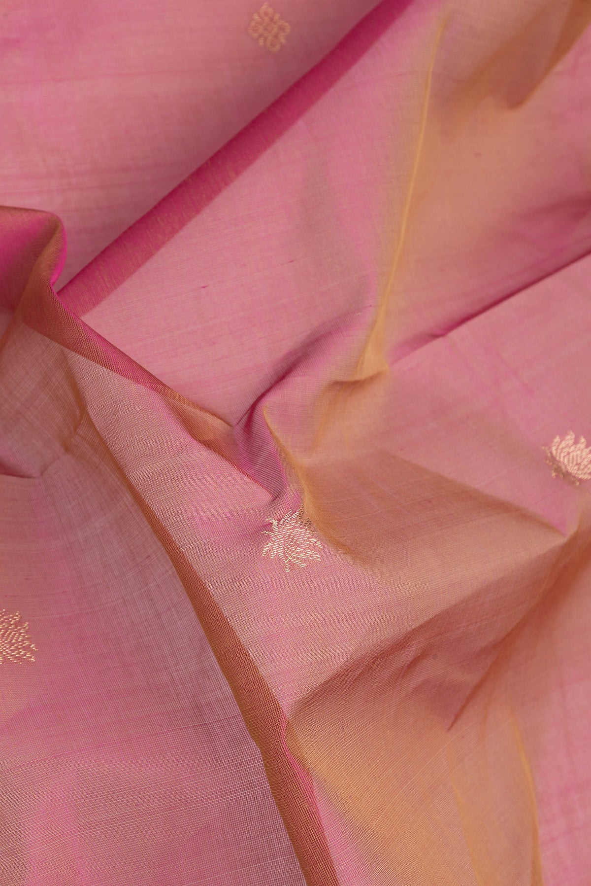 Close up of Pink Dual Tone Silk Cotton Saree with Zari Butta on the body and Zari Border.  displaying folds