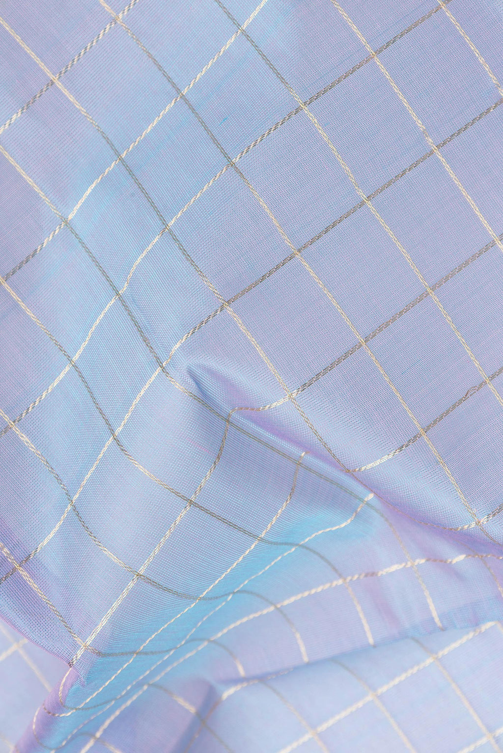 Close up of Peacock Blue Dual Tone Silk Cotton Saree with Checked design on the body and Zari And Thread Border.  displaying folds