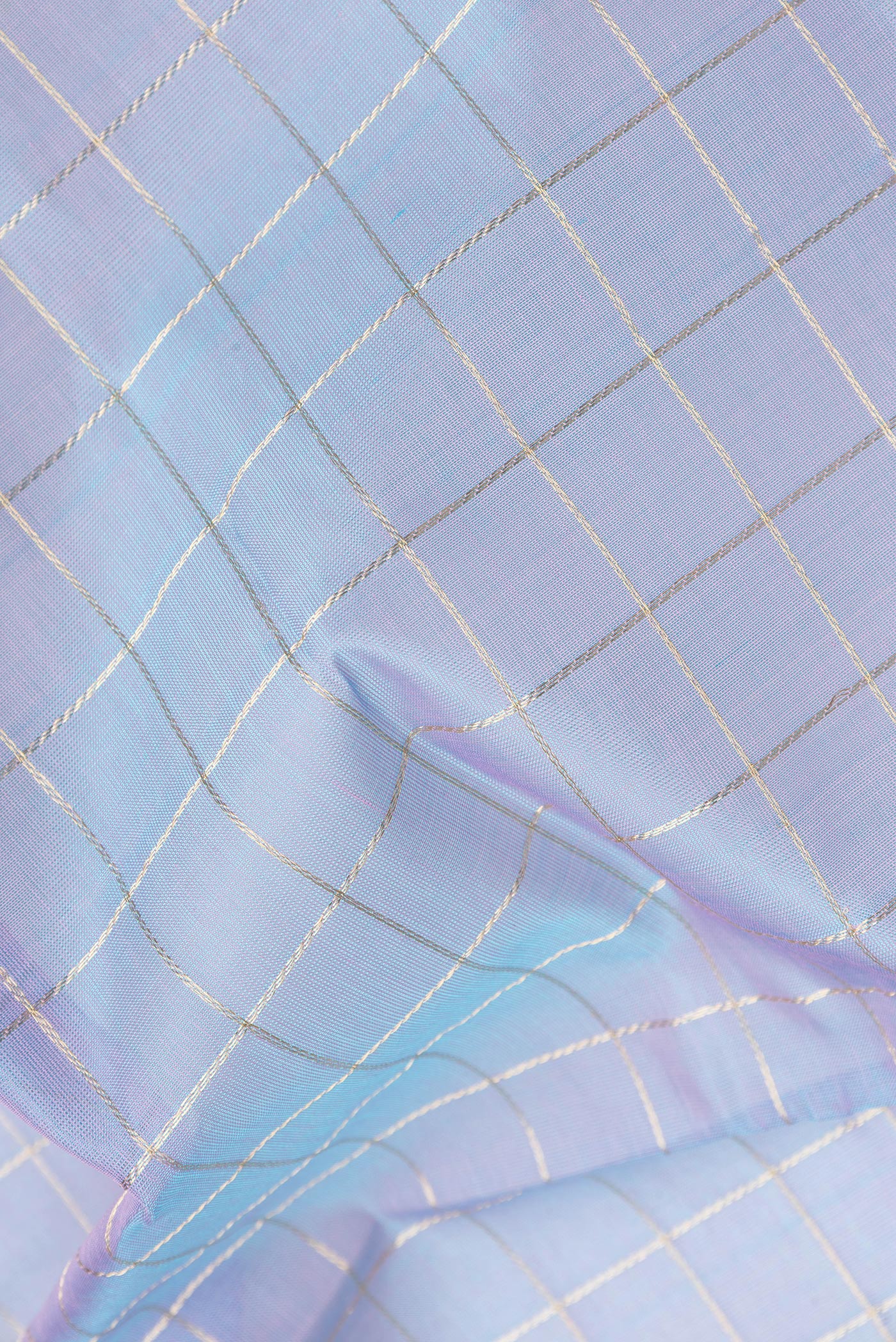 Close up of Peacock Blue Dual Tone Silk Cotton Saree with Checked design on the body and Zari And Thread Border.  displaying folds