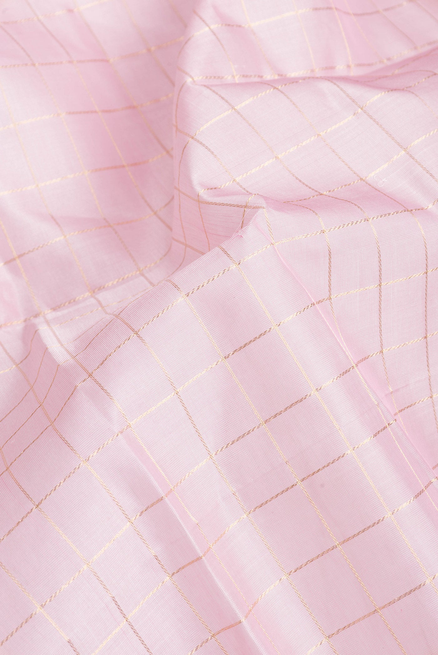 Close up of Pink Dual Tone Silk Cotton Saree with Checked design on the body and Zari And Thread Border.  displaying folds