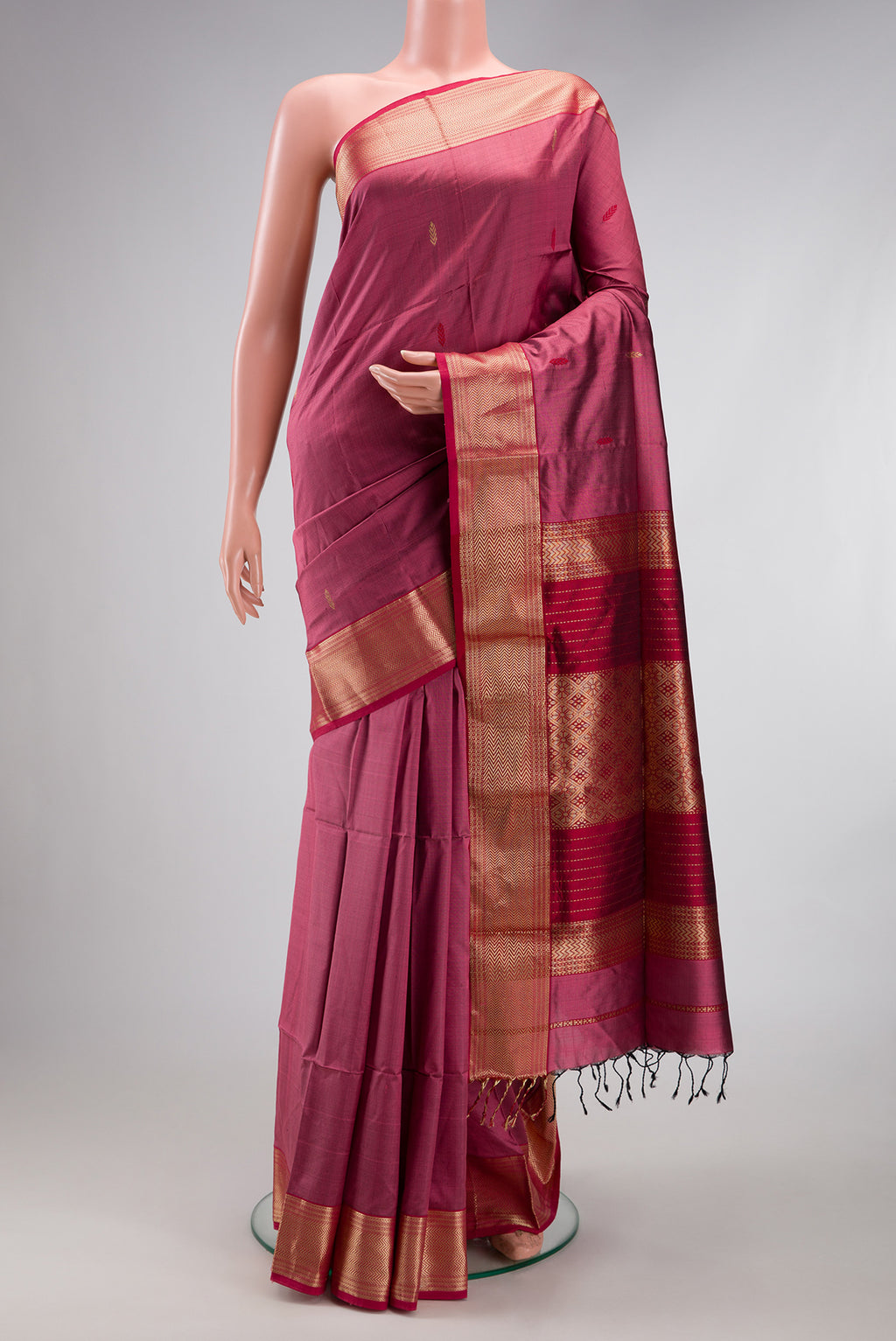 Pink Maheshwari Silk Saree with Zari And Thread Butta on the body and Zari Border.  displayed on a mannequin