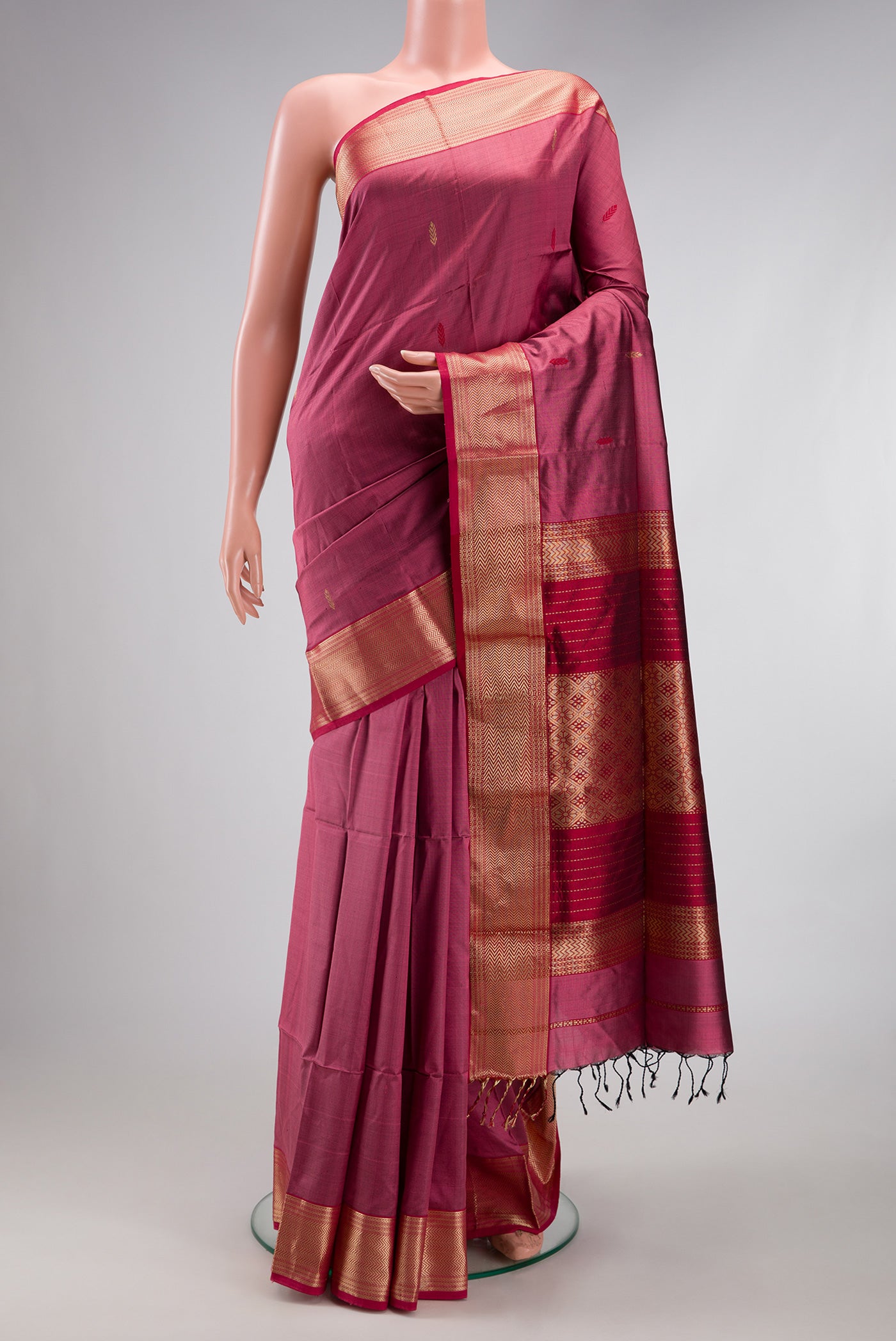 Pink Maheshwari Silk Saree with Zari And Thread Butta on the body and Zari Border.  displayed on a mannequin