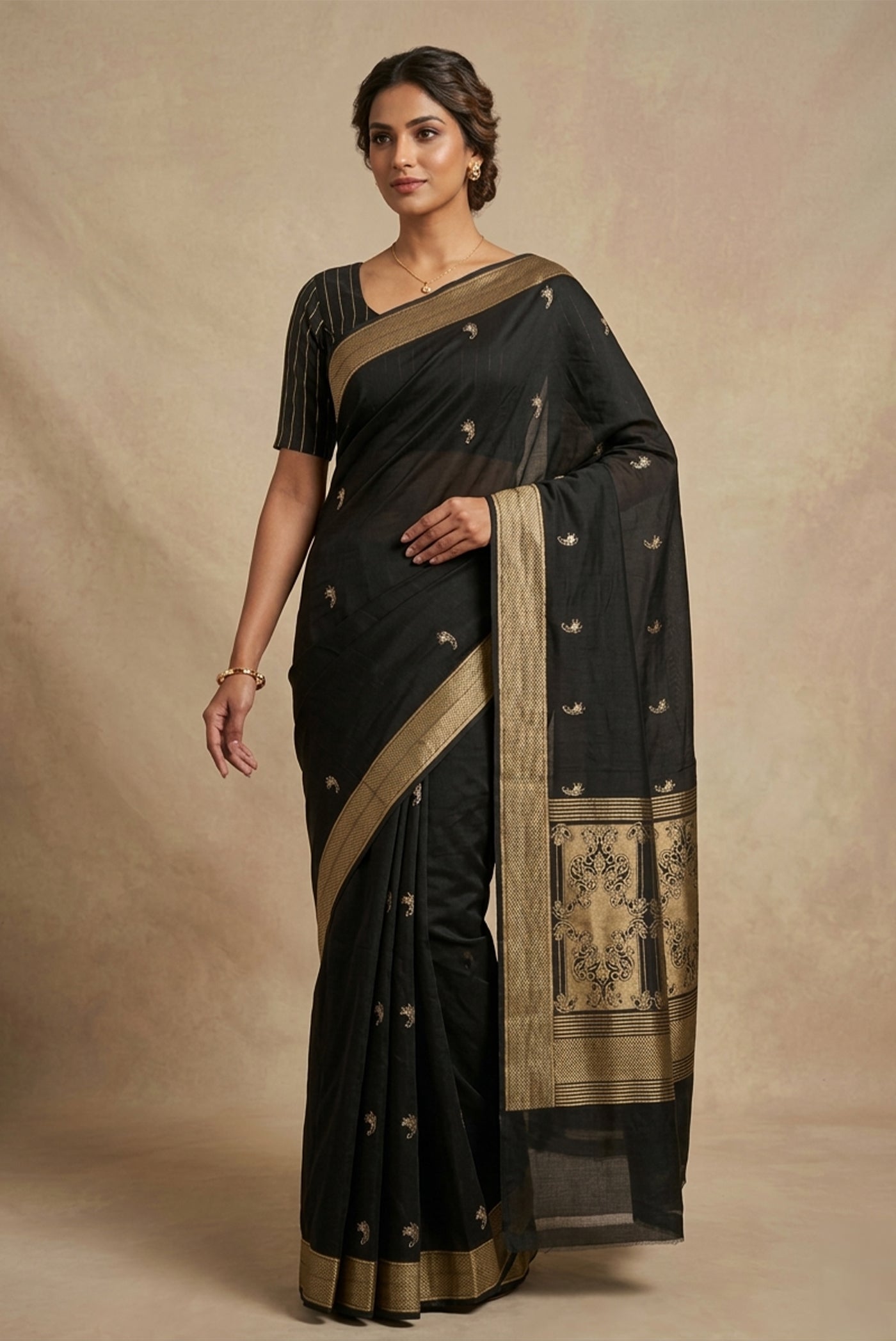 Model wearing a Shyama, handwoven in rich Katan silk, brings together the finesse of the kadhua technique with the quiet duality of gold zari and silver meenakari. Inspired by the stylised lilies of Art Nouveau, naturalistic lily butis bloom in a neat, straight repeat across the body. Solid gold twill borders and a bold twill pallu, framed with delicate lily motifs and silver meenakari accents, lend the saree depth and refined balance.