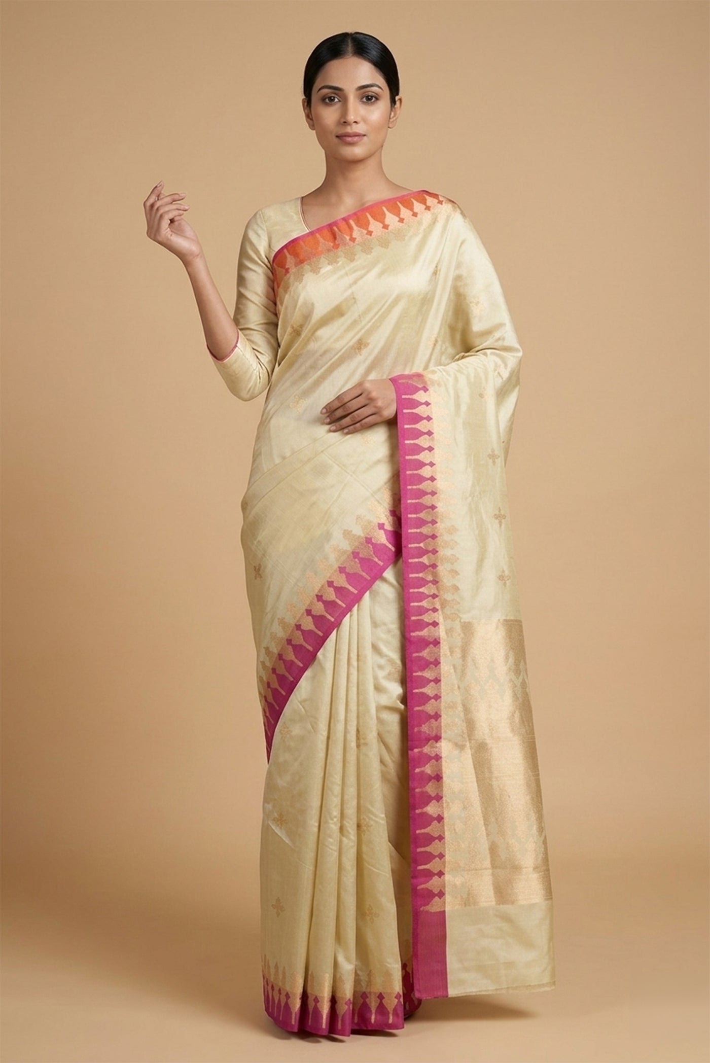 Model wearing a Mahima, handwoven in silk with satin borders and crafted using the kadhua technique, brings together contemporary form and traditional artistry. Inspired by Dhokra brass sculptures, the body features a four-petal flower with concentric detailing. Contrasting satin-woven sections within ornamental zari arches define the Ganga?Jamuna border, while a rich pallu adds depth and quiet grandeur.