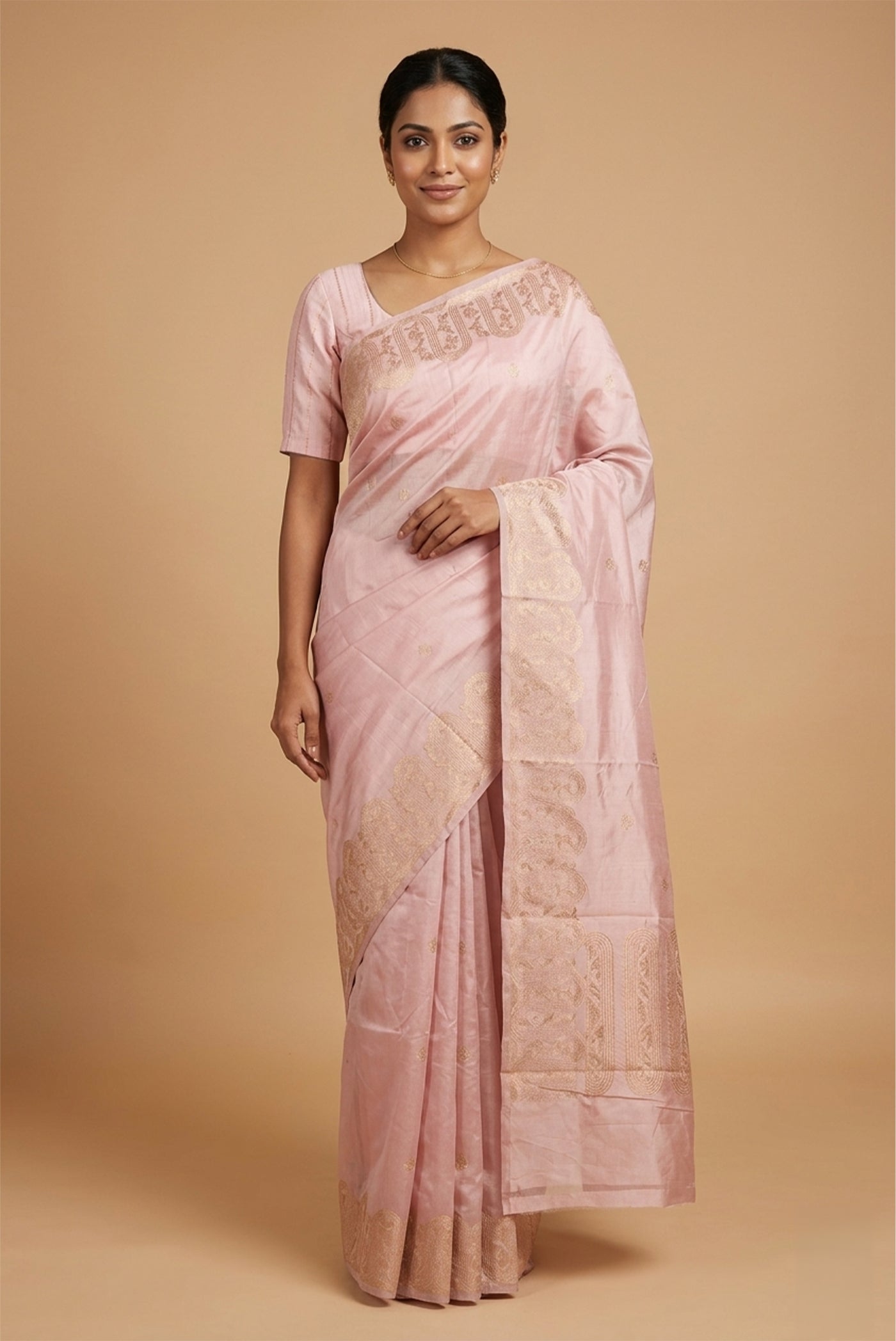 Model wearing a Mandhara, handwoven in Katan silk, brings together kadhua weaving and delicate meenakari detailing. Crafted in gold zari with silver accents, the saree draws from Art Nouveau florals and the concentric forms of Dhokra metal craft. Wavy, concentric borders with floral vines frame the design, while tiny silver-meenakari butis dot the body. The pallu completes the saree with elongated floral panels, lending a balanced, composed finish.