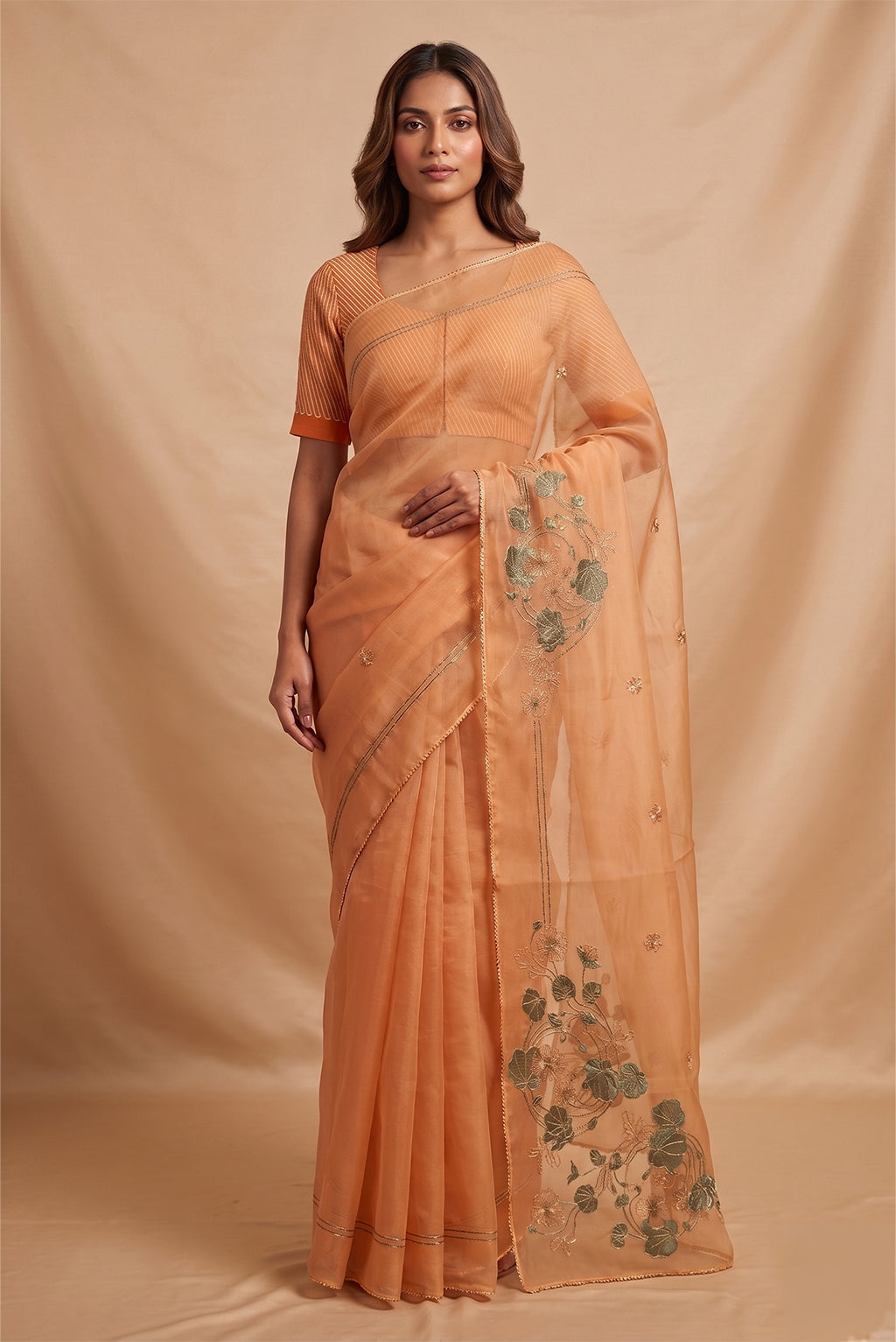 Model wearing a Aboli-Apricot Orange Organza Silk Saree