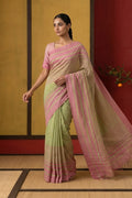 Model wearing a Titli, framed with proportioned stripes that gradually narrow towards the body, bringing together a vibrant palette in harmony. Where the border and pallu stripes meet, tiny checks appear, evoking abstract butterflies - delicate creatures of spring and summer. The plain body offers soft contrast, allowing the colours to shine. On the pallu, these stripes return as subtle checks, adding a light, balanced finish.