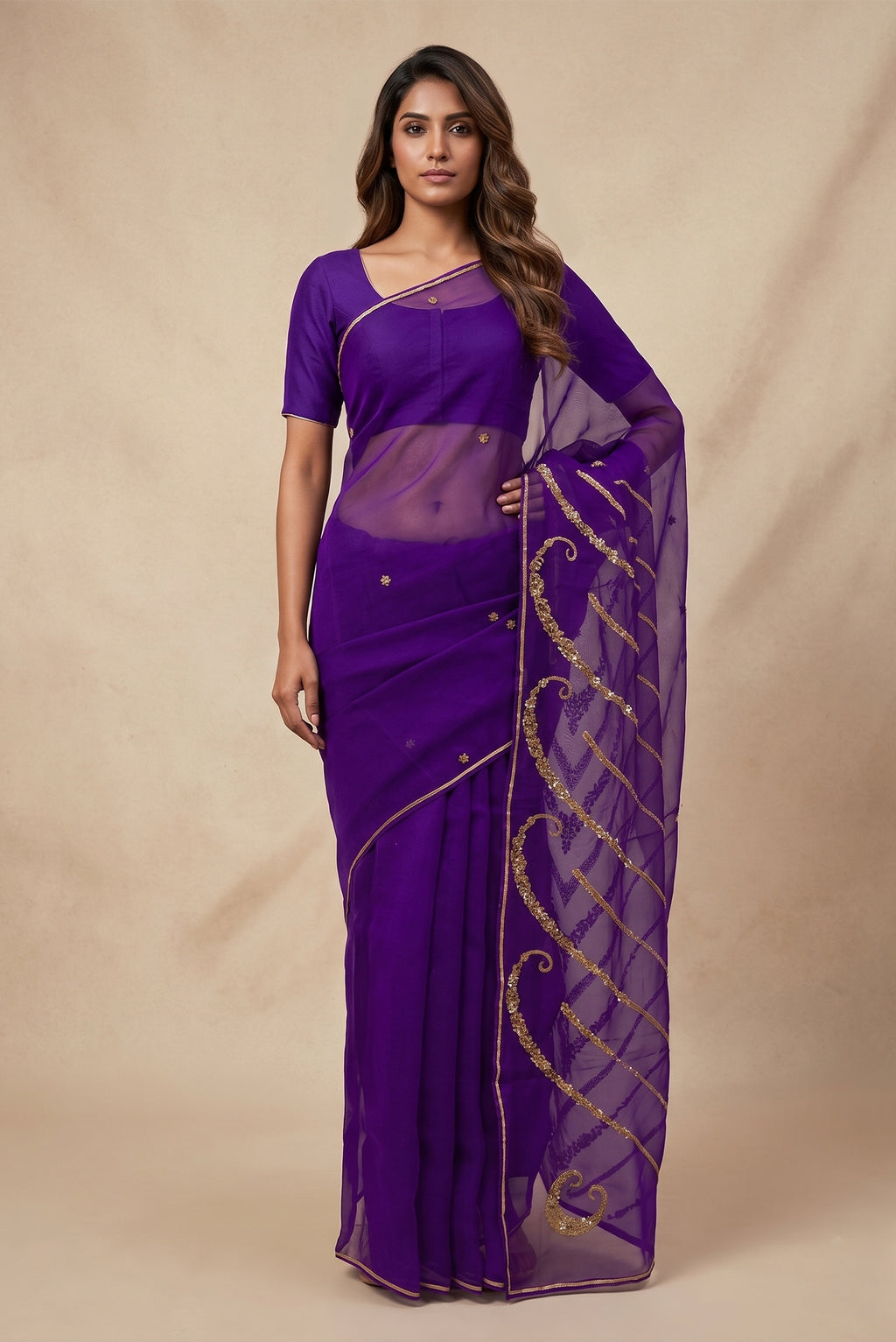 Model wearing a Sitara, crafted in silk organza and embroidered in antique-gold zardozi, draws from Art Nouveau?s love for organic, nature-led forms and the graceful contours of butterfly wings. The pallu features striking V-shaped motifs filled with floral embroidery, worked in dabka, sequins, and beads, alternating between dense and lighter forms. A minimal floral body allows the statement pallu to unfold with soft grandeur.