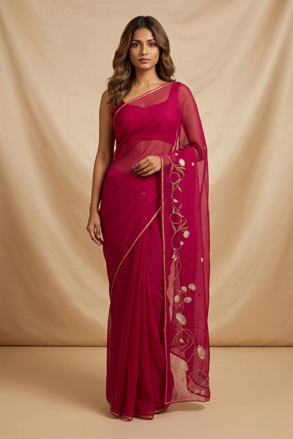 Model wearing a Bahar, crafted in silk organza, features delicate pani-zari enriched with zardozi, gota work, and dabka embroidery. Its defining element is an off-center floral vine running vertically through the body, breaking symmetry with quiet intent. Inspired by Art Nouveau?s flowing lines, the vine is rendered in slender leaves, zari chain-stitched stems, and alternating gota and zardozi flowers. The pallu trails gently onto the body in scattered embroidered blooms.