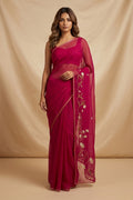 Model wearing a Bahar, crafted in silk organza, features delicate pani-zari enriched with zardozi, gota work, and dabka embroidery. Its defining element is an off-center floral vine running vertically through the body, breaking symmetry with quiet intent. Inspired by Art Nouveau?s flowing lines, the vine is rendered in slender leaves, zari chain-stitched stems, and alternating gota and zardozi flowers. The pallu trails gently onto the body in scattered embroidered blooms.