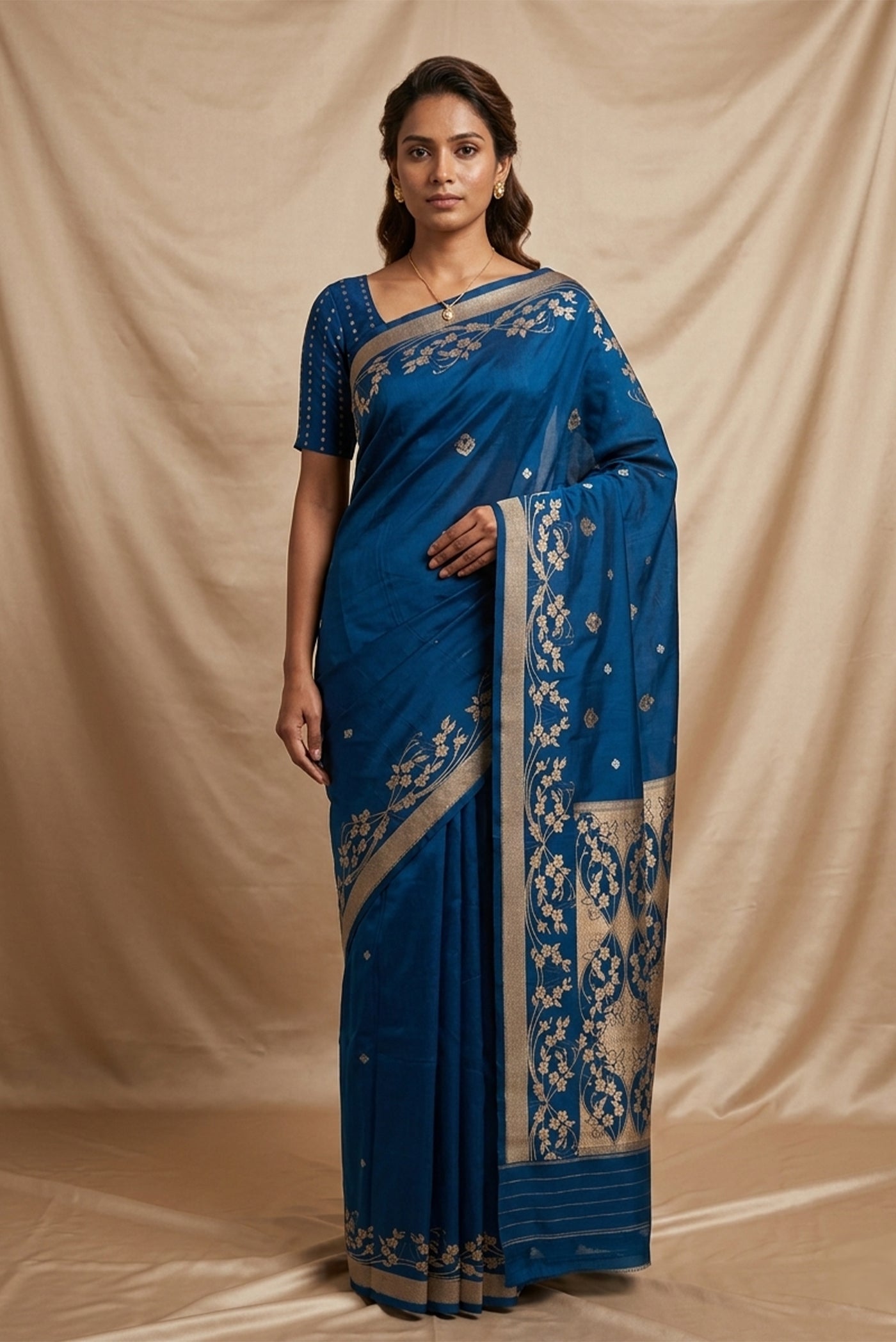 Model wearing a Gul from the collection draws from Art Nouveau curves and ornamental florals. Handwoven in Katan silk with rich gold zari using the Kadhua technique, the body features delicate floral butas and three-flower clusters. Solid twill borders hold soft wreaths of flowers and vines, while an ornate brocade pallu extends the motif in exquisite detail, an elegant expression of Banarasi craftsmanship.