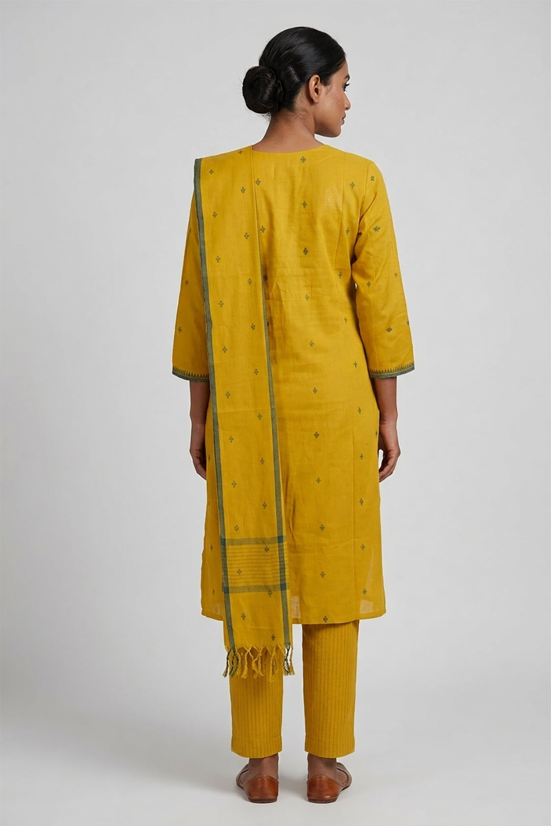 Mustard Pure Cotton Womens Kurta set featuring Thread Butta Kurta paired with Mustard Stripes bottom and a Thread Butta dupatta in Mustard back image displayed on an AI model