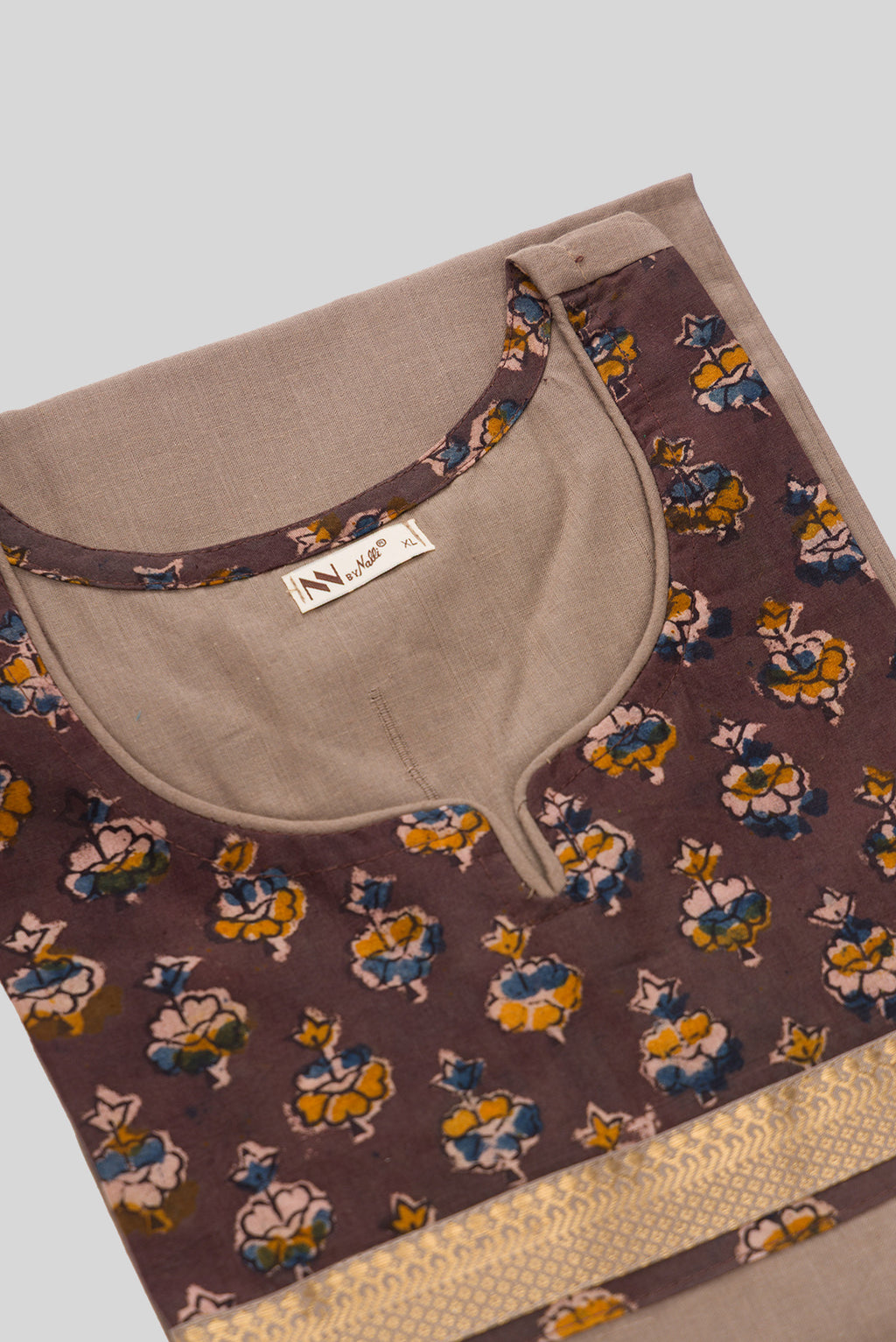 Detailed shot of This Beige Cotton Kurta is crafted using Plain Woven detailing, featuring Plain Body design across the silhouette with Round neck