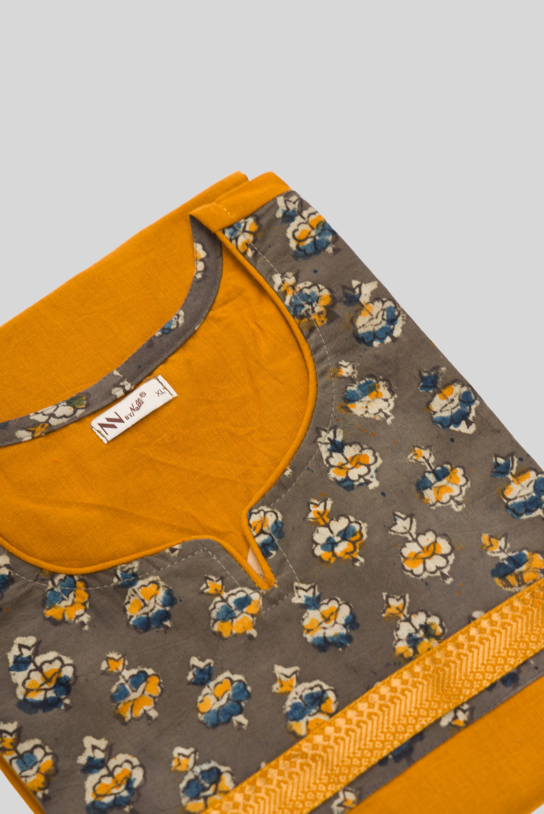 Detailed shot of This Mustard Cotton Kurta is crafted using Plain Woven detailing, featuring Plain Body design across the silhouette with Round neck