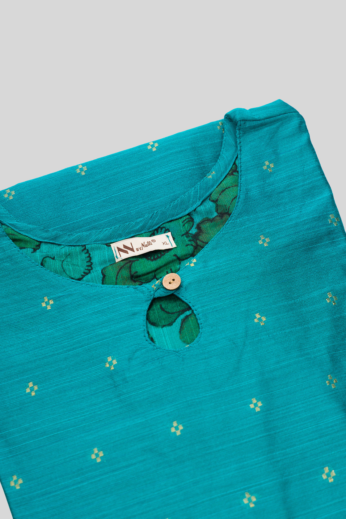 Detailed shot of This Turquoise Cotton Kurta is crafted using Woven Design detailing, featuring Thread Butta design across the silhouette with Keyhole neck