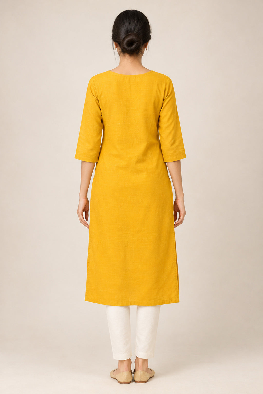 This Yellow Cotton Kurta is crafted using Woven Design detailing, featuring Thread Butta design across the silhouette with Round neck back image displayed on an AI model