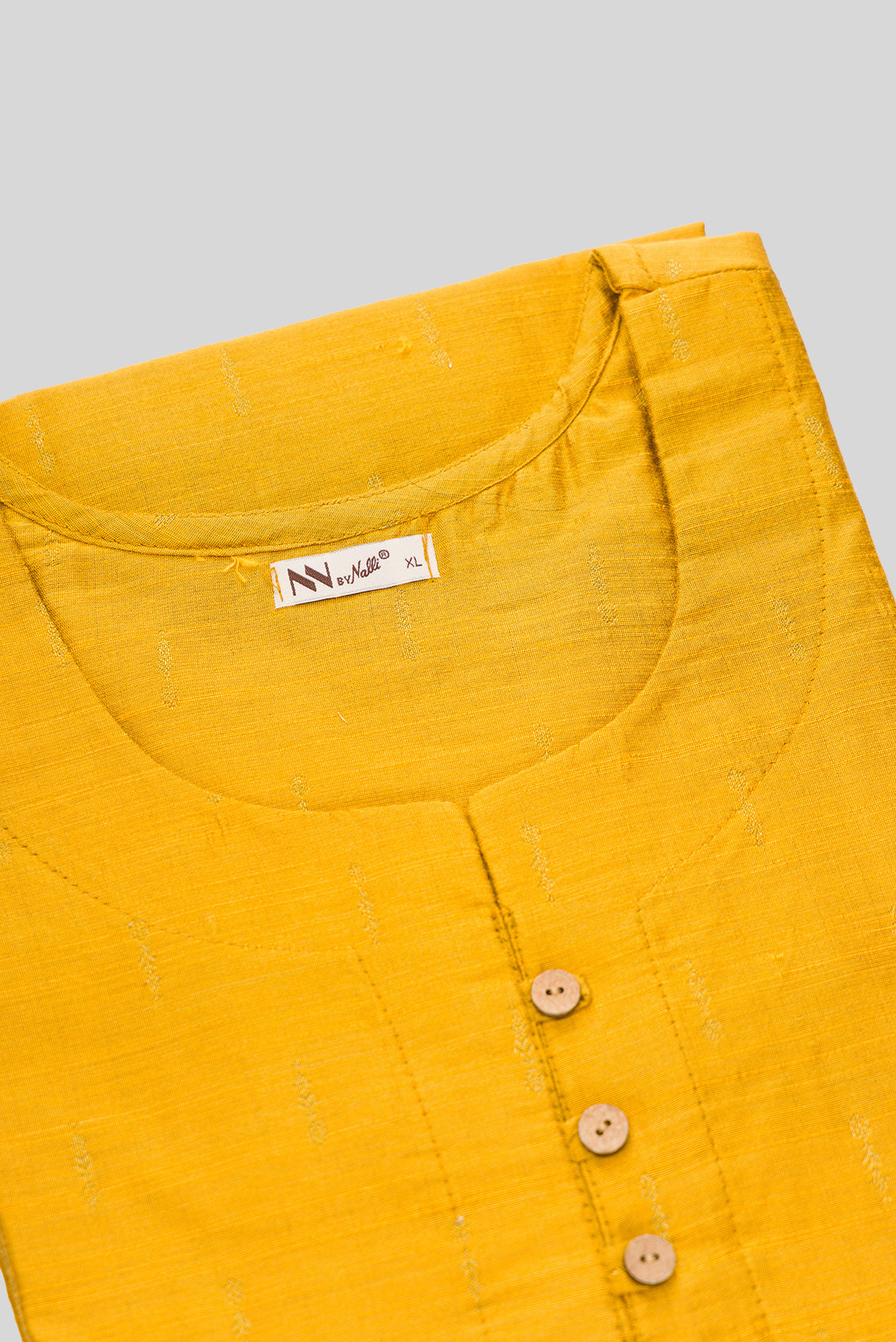 Detailed shot of This Yellow Cotton Kurta is crafted using Woven Design detailing, featuring Thread Butta design across the silhouette with Round neck