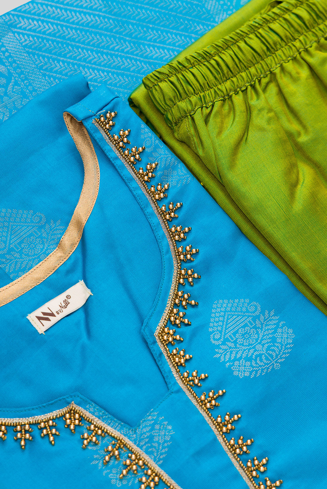 Detailed shot of Sky Blue Pure Silk Womens Kurta set featuring Zari Butta Kurta paired with Mehandi Green Plain Body bottom and a Zari Butta dupatta in Mehandi Green
