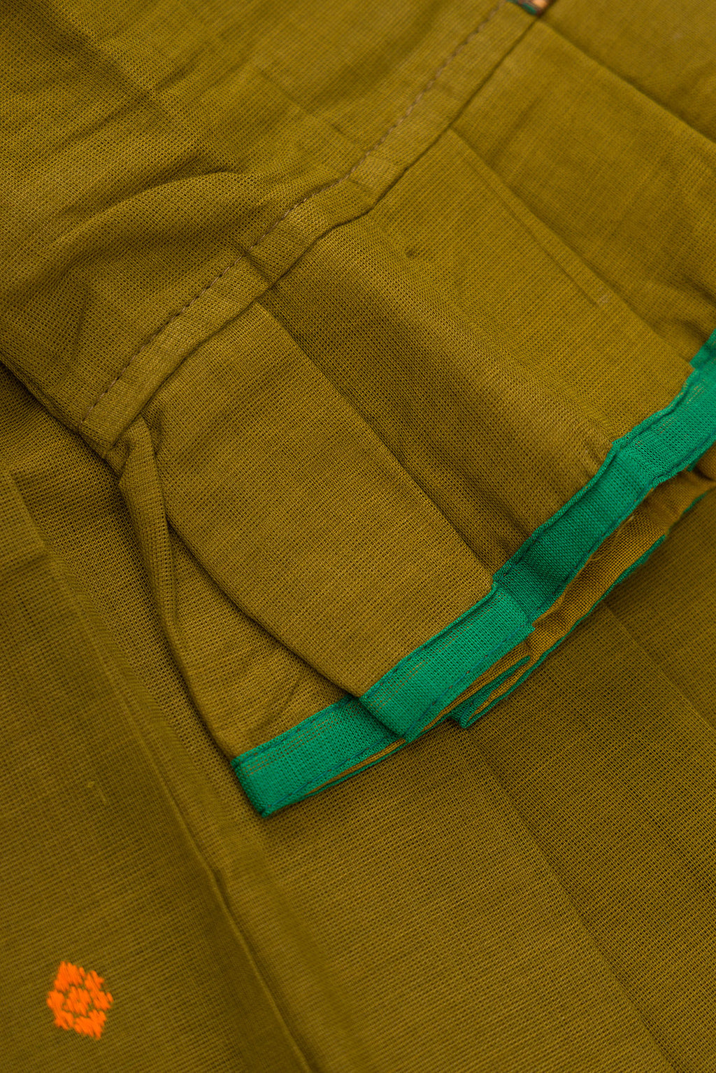 Detailed shot of Green Readymade Cotton Pavadai Set with Zari Butta on the body and Thread Border