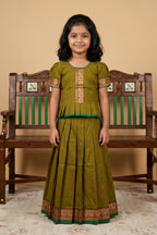 Green Readymade Cotton Pavadai Set with Zari Butta on the body and Thread Border displayed on a mannequin