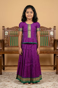 Green Readymade Cotton Pavadai Set with Zari Butta on the body and Thread Border displayed on a mannequin