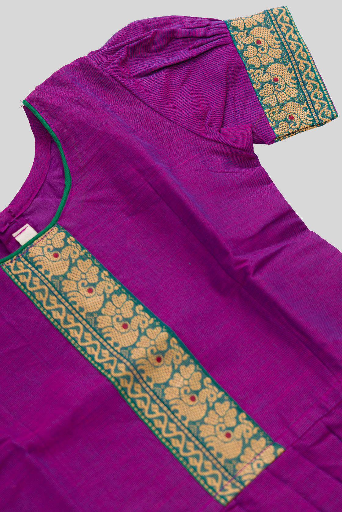 Close up sleeve details of Green Readymade Cotton Pavadai Set with Zari Butta on the body and Thread Border