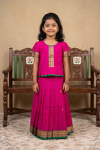 Green Readymade Cotton Pavadai Set with Zari Butta on the body and Thread Border displayed on a mannequin