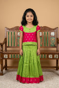 Green Readymade Cotton Pavadai Set with Zari Butta on the body and Fancy Border displayed on a mannequin