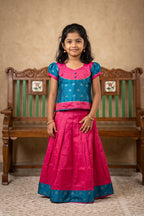 Green Readymade Cotton Pavadai Set with Zari Butta on the body and Fancy Border displayed on a mannequin