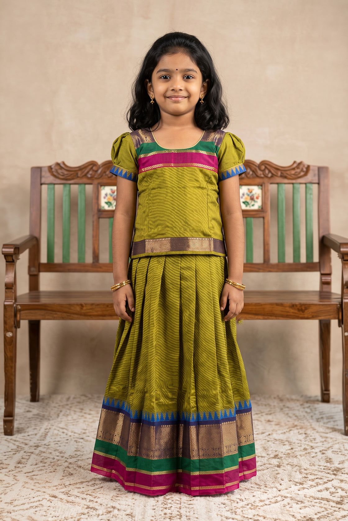 Mehandi Green Readymade Cotton Pavadai Set with Zari Butta on the body and Temple Border displayed on a mannequin