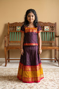 Mehandi Green Readymade Cotton Pavadai Set with Zari Butta on the body and Zari And Thread Border displayed on a mannequin