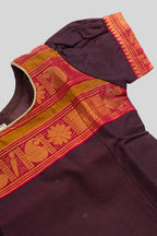 Close up sleeve details of Mehandi Green Readymade Cotton Pavadai Set with Zari Butta on the body and Zari And Thread Border