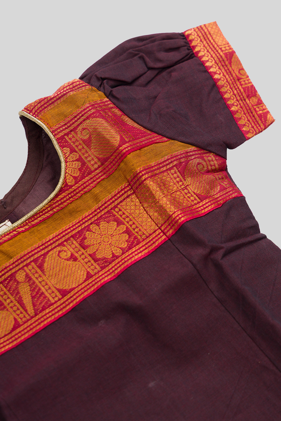 Close up sleeve details of Mehandi Green Readymade Cotton Pavadai Set with Zari Butta on the body and Zari And Thread Border