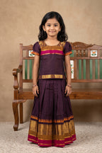 Mehandi Green Readymade Cotton Pavadai Set with Zari Butta on the body and Zari And Thread Border displayed on a mannequin