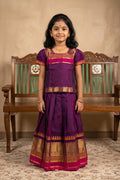 Mehandi Green Readymade Cotton Pavadai Set with Zari Butta on the body and Zari And Thread Border displayed on a mannequin
