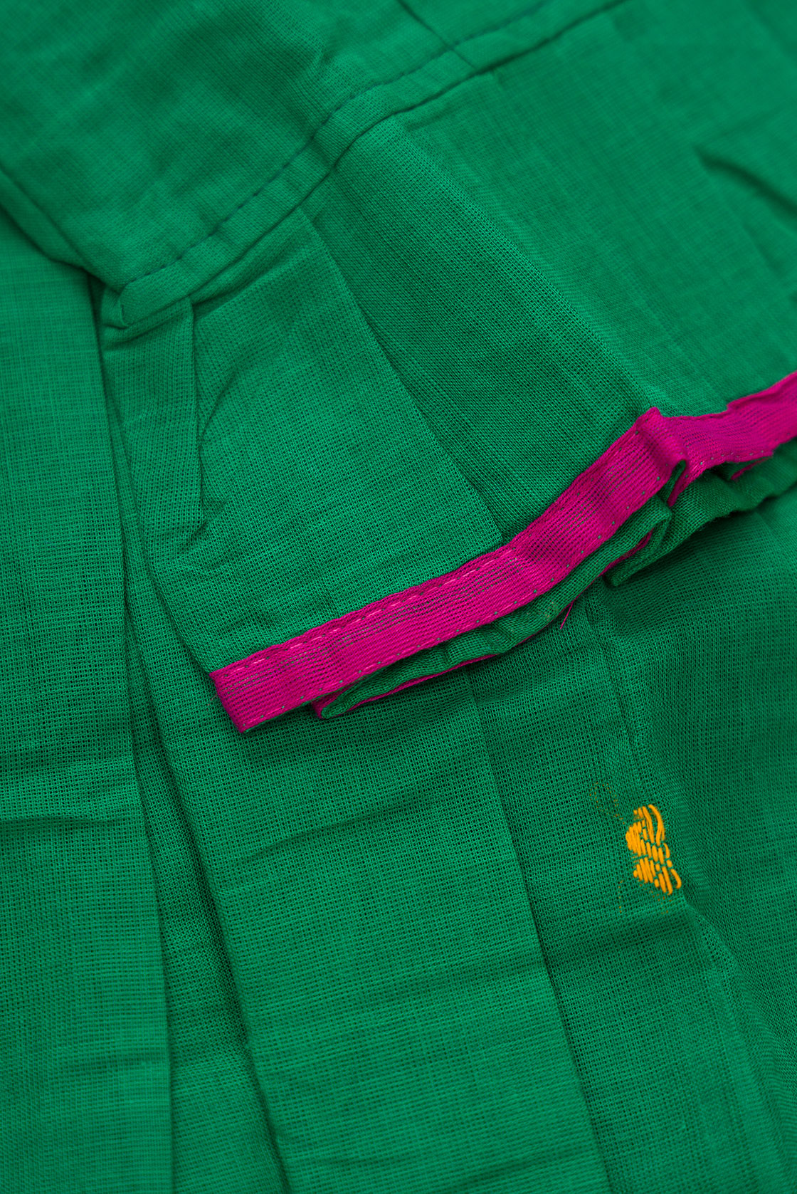 Detailed shot of Mehandi Green Readymade Cotton Pavadai Set with Zari Butta on the body and Thread Border