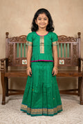 Mehandi Green Readymade Cotton Pavadai Set with Zari Butta on the body and Thread Border displayed on a mannequin