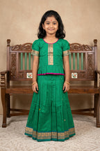 Mehandi Green Readymade Cotton Pavadai Set with Zari Butta on the body and Thread Border displayed on a mannequin