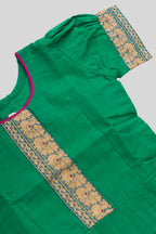Close up sleeve details of Mehandi Green Readymade Cotton Pavadai Set with Zari Butta on the body and Thread Border