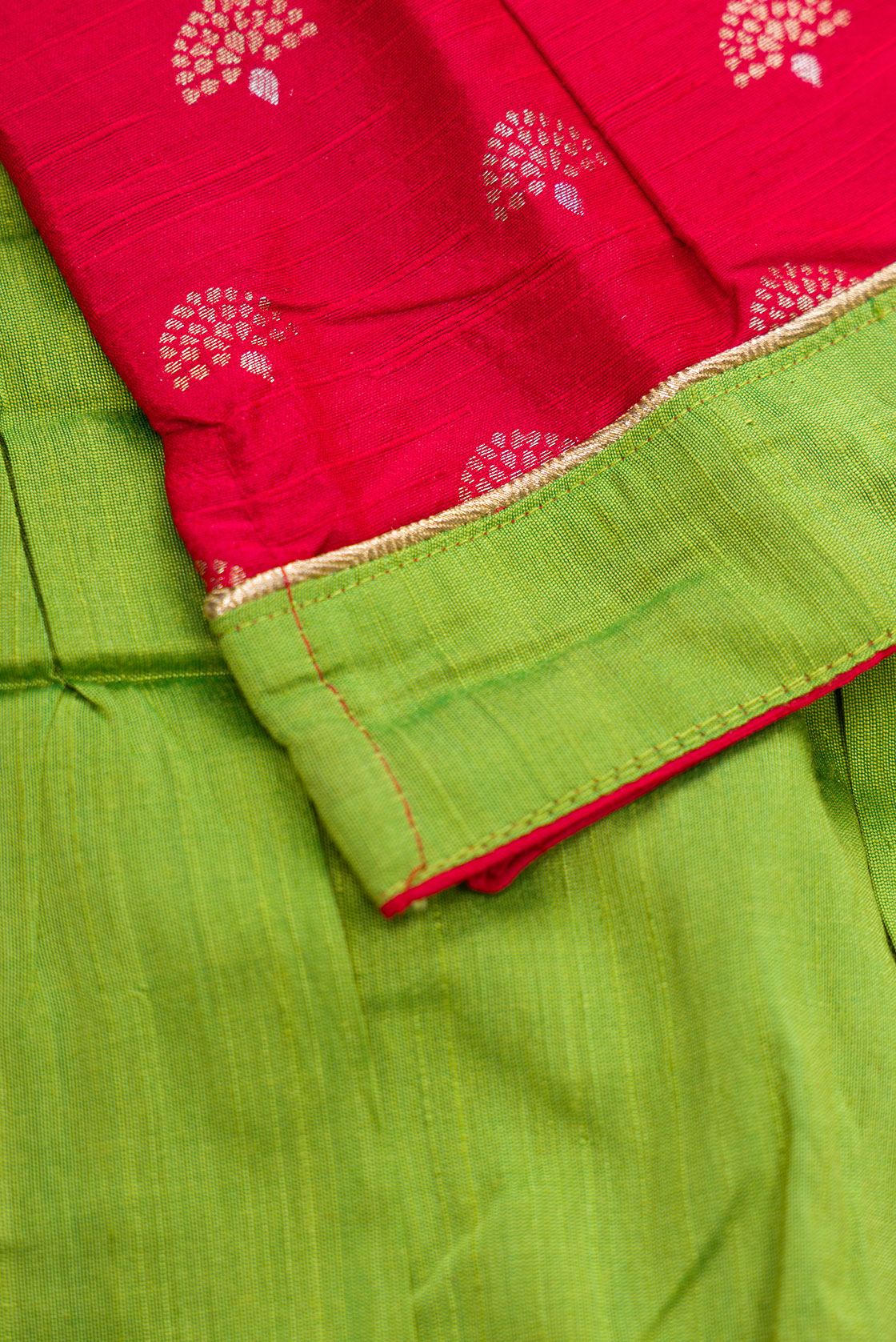 Detailed shot of Parrot Green Readymade Cotton Pavadai Set with Zari Butta on the body and Fancy Border