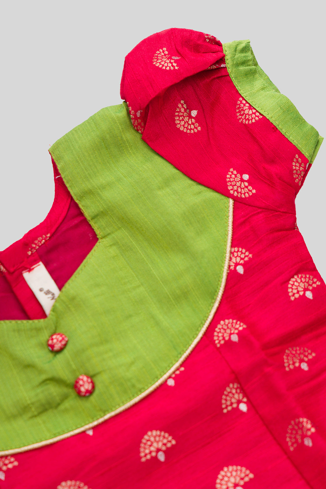 Close up sleeve details of Parrot Green Readymade Cotton Pavadai Set with Zari Butta on the body and Fancy Border