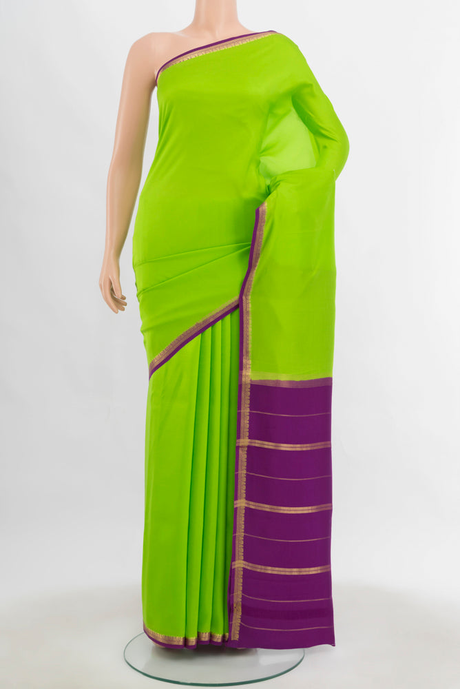 Parrot Green Mysore Crepe Saree with Plain Body and Silk Border.  displayed on a mannequin